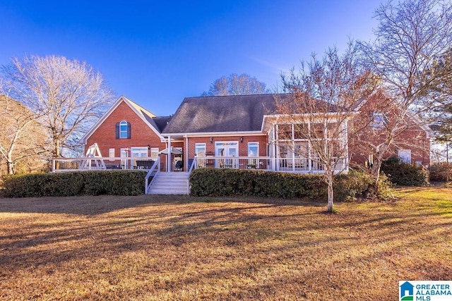 view of front of property featuring a front lawn and a sunroom