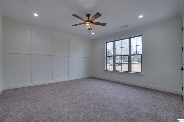 spare room with light carpet, ceiling fan, and crown molding