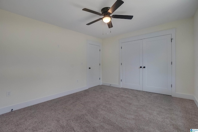 unfurnished bedroom with ceiling fan, a closet, and light colored carpet