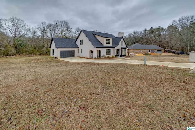 view of front of property with a front lawn and a garage