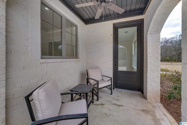 entrance to property featuring ceiling fan and a patio