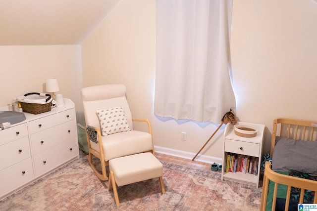 bedroom with a crib and vaulted ceiling