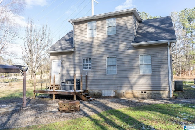 rear view of property with central AC unit and a wooden deck