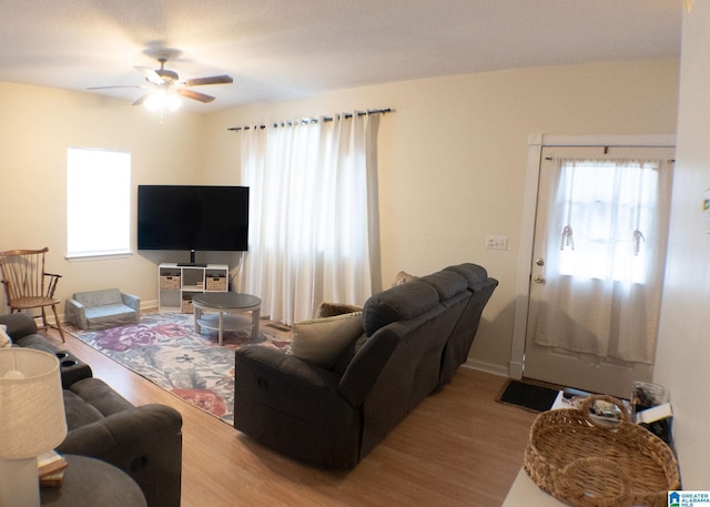 living room featuring hardwood / wood-style flooring and ceiling fan