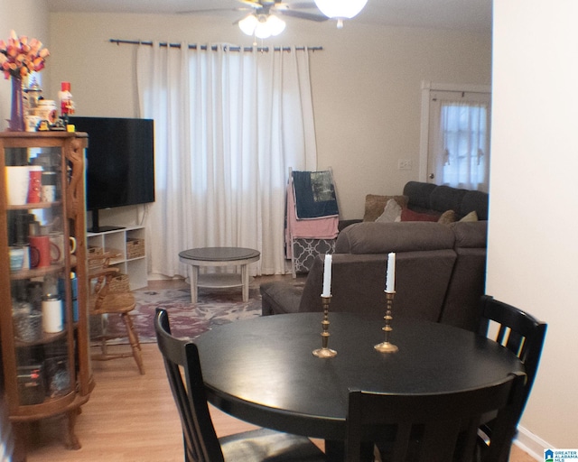 dining space with hardwood / wood-style floors and ceiling fan