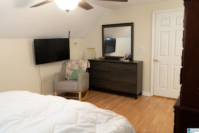 bedroom featuring ceiling fan, vaulted ceiling, and light wood-type flooring