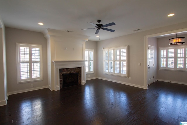 unfurnished living room featuring a fireplace, plenty of natural light, and ceiling fan