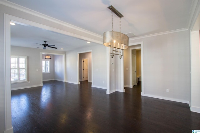 spare room featuring crown molding, dark hardwood / wood-style flooring, and ceiling fan with notable chandelier