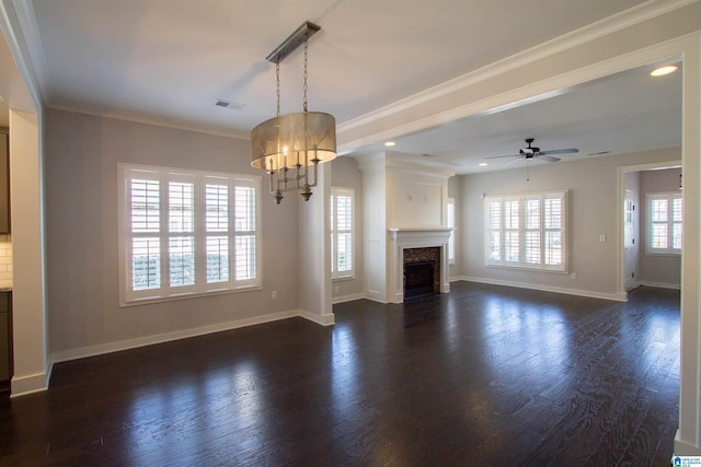 unfurnished living room featuring ceiling fan with notable chandelier, dark hardwood / wood-style flooring, and ornamental molding