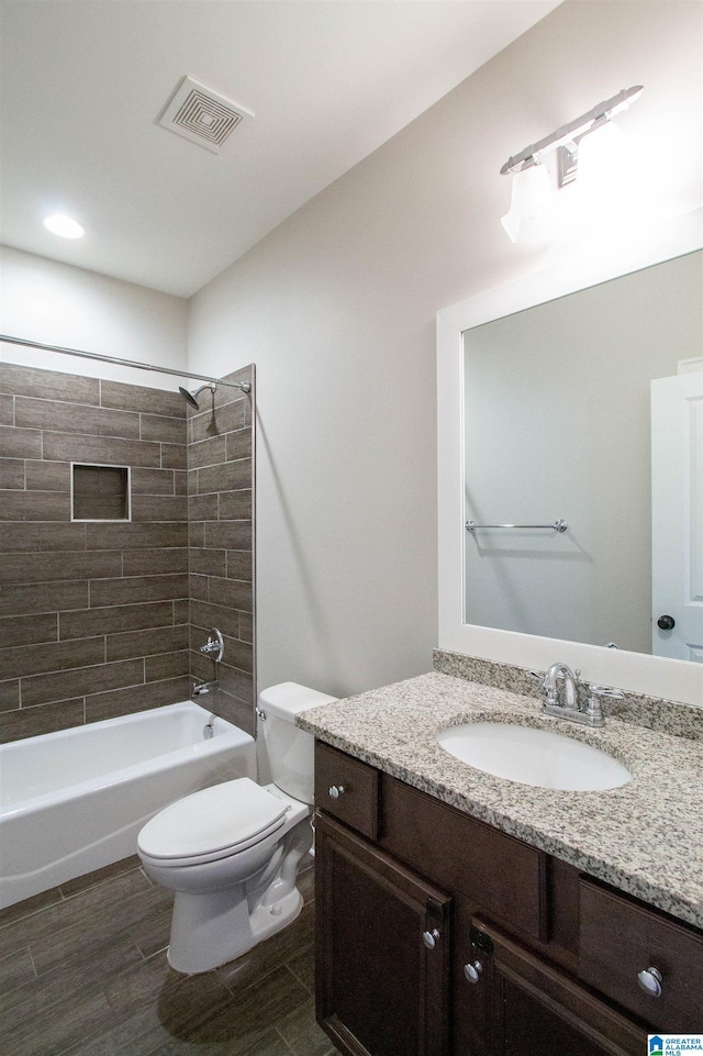 full bathroom with vanity, toilet, and tiled shower / bath