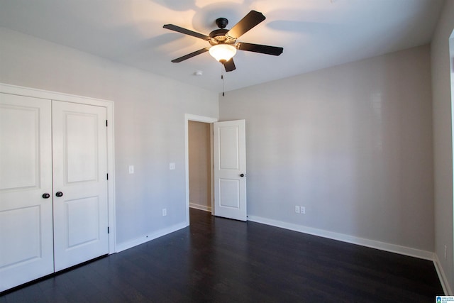 unfurnished bedroom featuring ceiling fan, a closet, and dark hardwood / wood-style floors