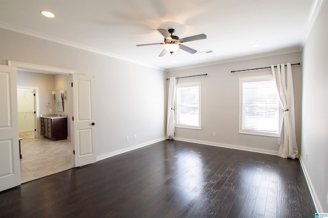 spare room with ceiling fan, crown molding, and dark wood-type flooring