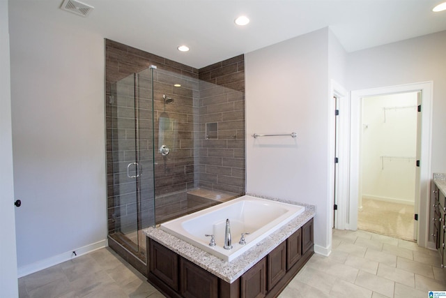 bathroom with separate shower and tub and tile patterned floors