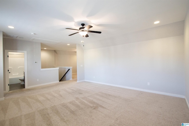 spare room featuring ceiling fan and light colored carpet