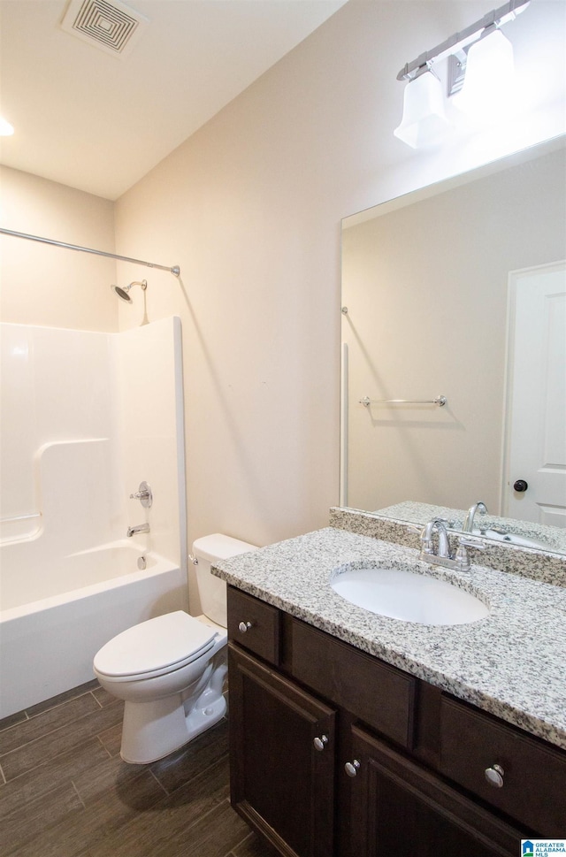 full bathroom with bathtub / shower combination, vanity, and toilet