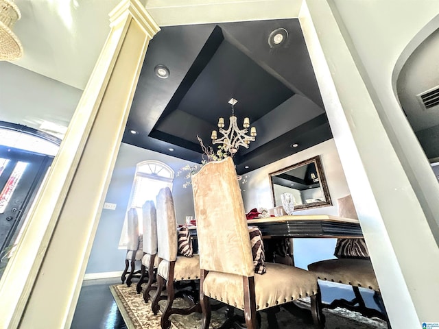 interior space featuring hardwood / wood-style floors and a raised ceiling