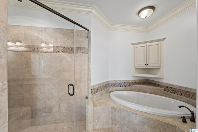 bathroom featuring ornamental molding and separate shower and tub