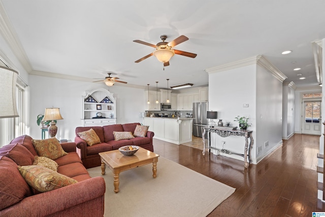 living room featuring ornamental molding, a wealth of natural light, and dark hardwood / wood-style floors