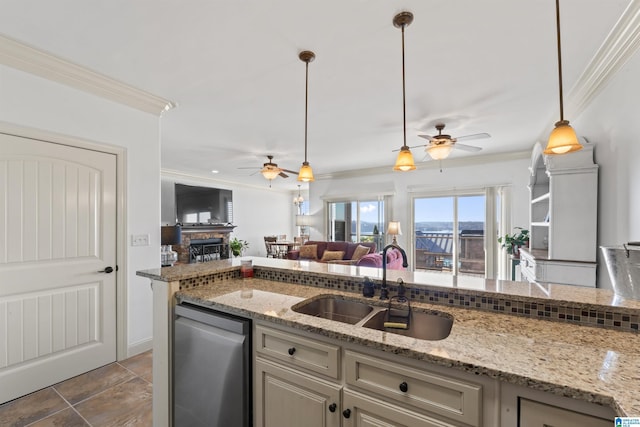 kitchen featuring sink, a brick fireplace, stainless steel dishwasher, and light stone countertops