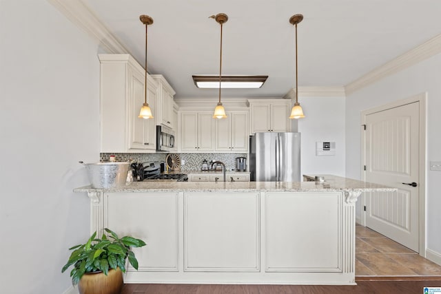 kitchen with stainless steel appliances, a kitchen bar, tasteful backsplash, light stone countertops, and pendant lighting