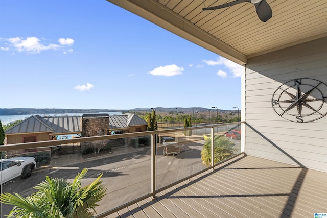 balcony featuring ceiling fan and a water view