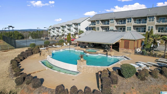 view of swimming pool with a community hot tub and a patio area