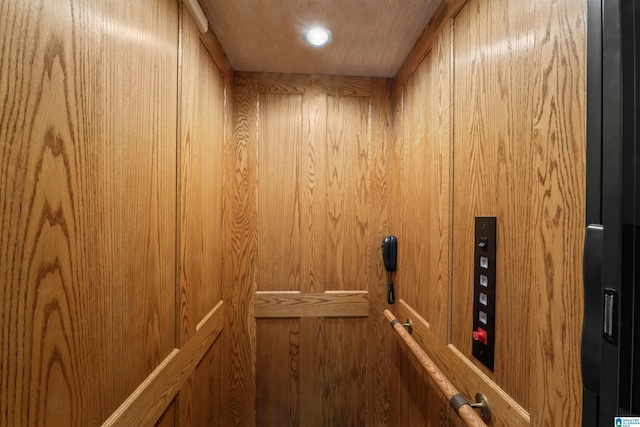 interior details featuring elevator and wood walls