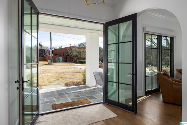 entryway featuring french doors, ornamental molding, and dark hardwood / wood-style flooring