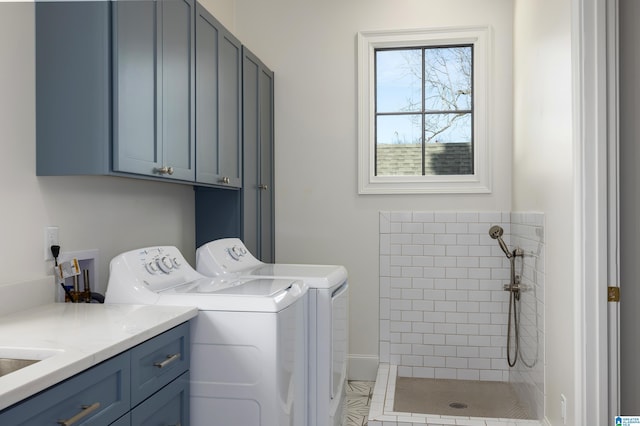 washroom with washing machine and dryer and cabinets