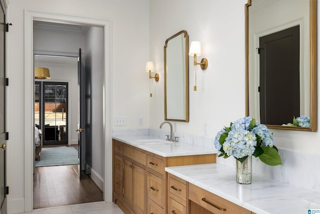 bathroom featuring ornamental molding and vanity