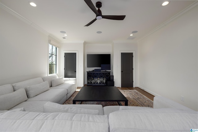 living room with ceiling fan, crown molding, and wood-type flooring