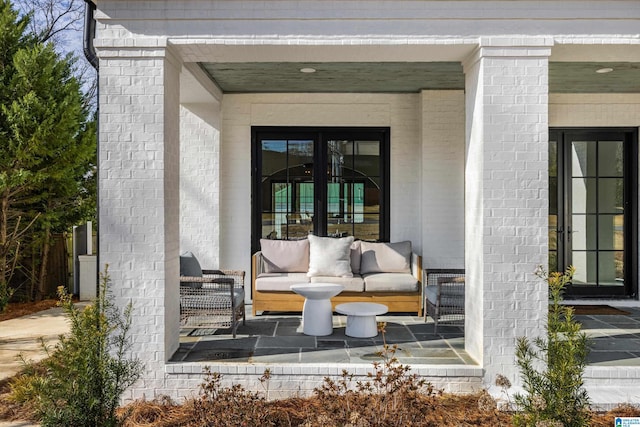 view of exterior entry with french doors and outdoor lounge area