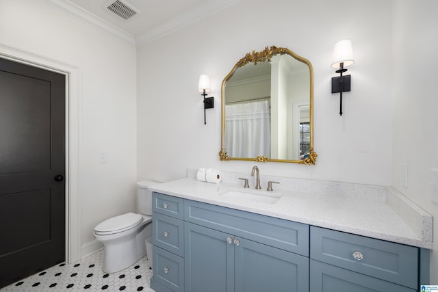 bathroom with tile patterned flooring, crown molding, vanity, and toilet