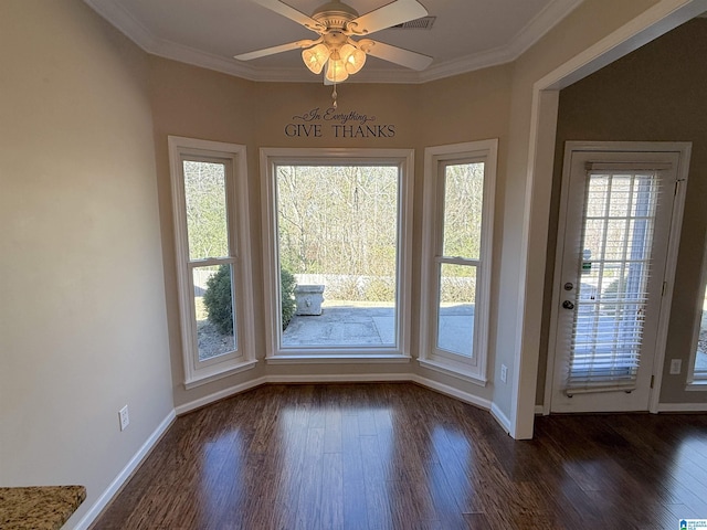 doorway with ornamental molding, ceiling fan, and dark wood-type flooring