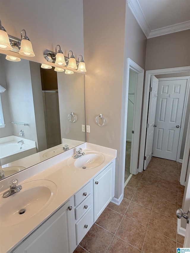 bathroom with tile patterned flooring, vanity, a tub to relax in, and ornamental molding