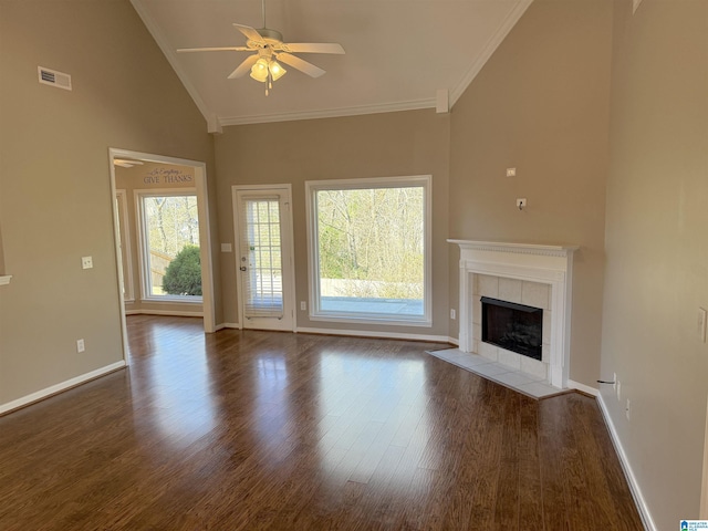 unfurnished living room featuring dark wood-type flooring, high vaulted ceiling, ceiling fan, ornamental molding, and a fireplace