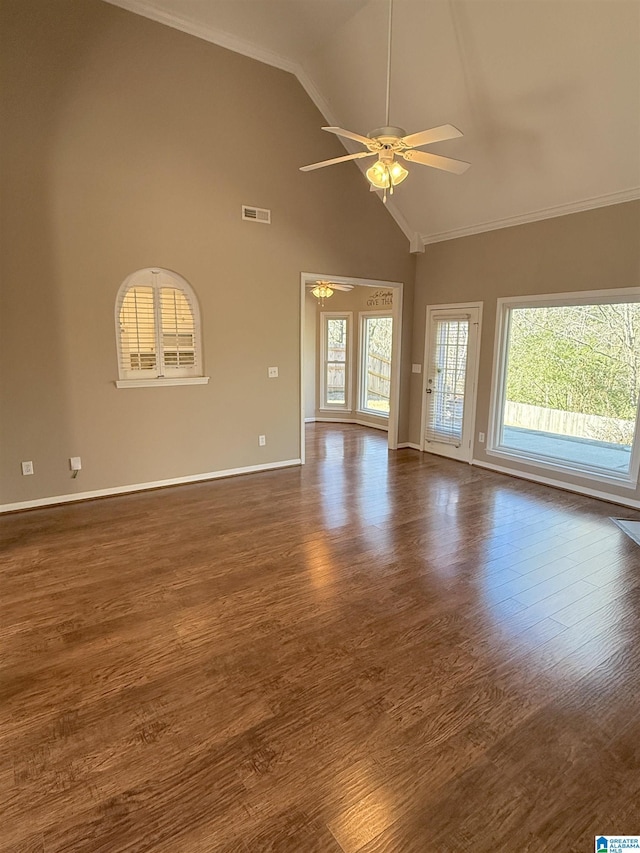 unfurnished living room featuring ceiling fan, dark hardwood / wood-style flooring, ornamental molding, and vaulted ceiling