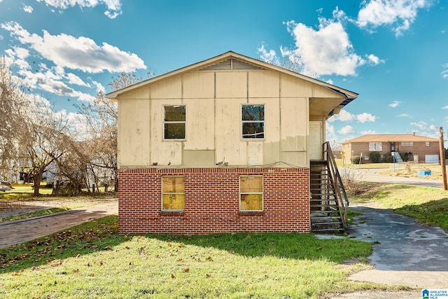 view of property exterior with a yard