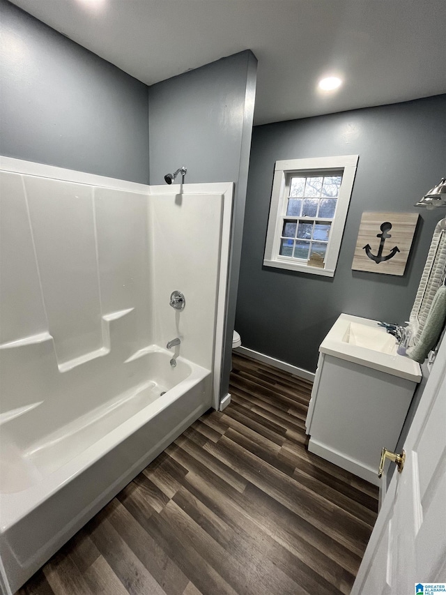 full bathroom with shower / bathing tub combination, vanity, toilet, and hardwood / wood-style floors