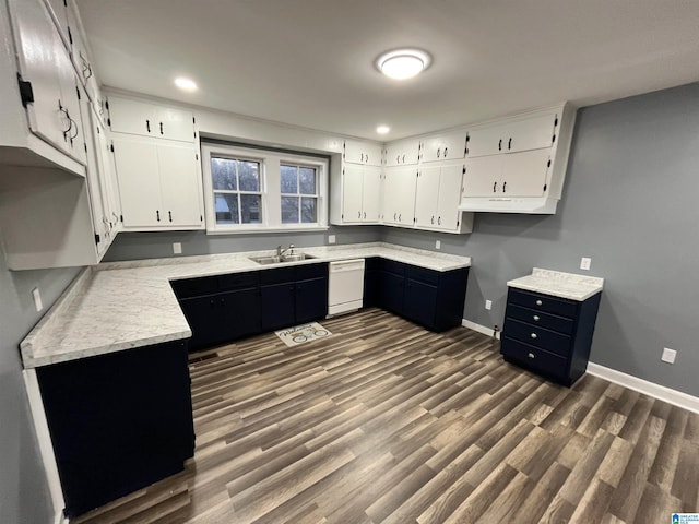 kitchen featuring dark hardwood / wood-style flooring, dishwasher, white cabinets, and sink