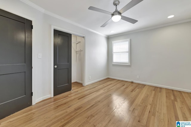 unfurnished bedroom with ceiling fan, light wood-type flooring, and ornamental molding