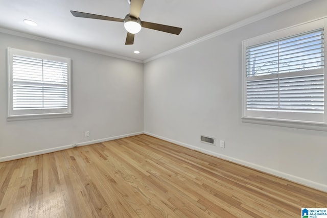 spare room featuring light wood-type flooring, ceiling fan, and crown molding