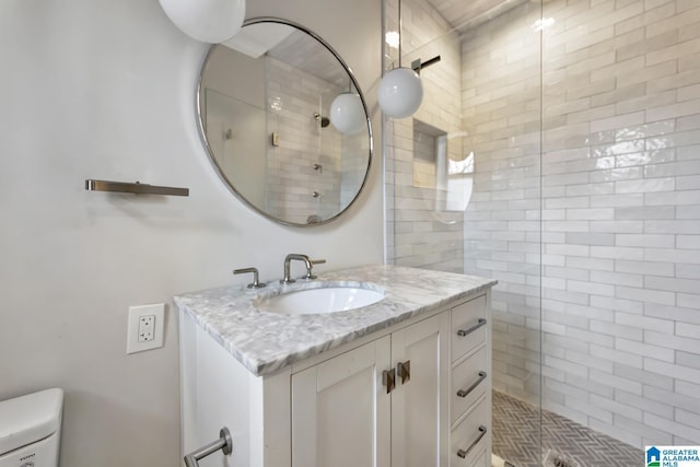 bathroom featuring walk in shower, vanity, and toilet