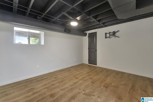 basement with hardwood / wood-style flooring