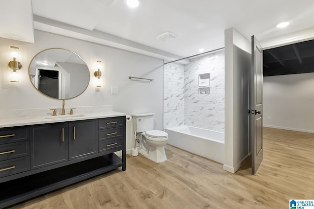 full bathroom with toilet, tiled shower / bath combo, vanity, and hardwood / wood-style floors