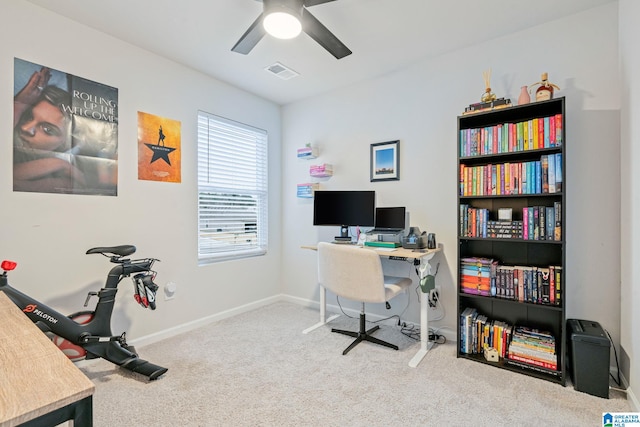 carpeted office featuring ceiling fan