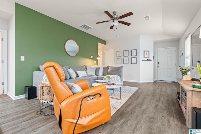 living room with ceiling fan, lofted ceiling, and hardwood / wood-style flooring