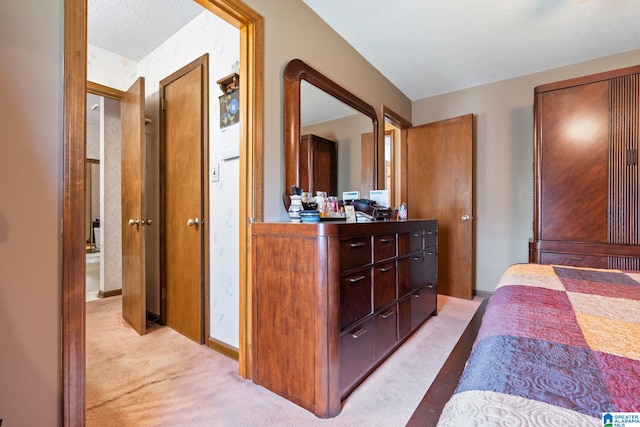 carpeted bedroom featuring a textured ceiling