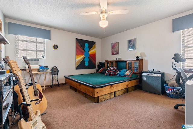 bedroom with carpet flooring, a textured ceiling, and ceiling fan