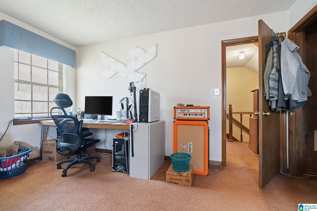 carpeted home office featuring a textured ceiling and vaulted ceiling